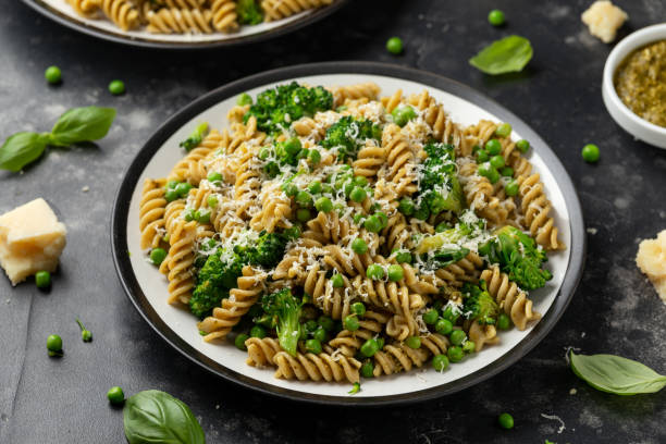 piselli verdi, pasta di broccoli con pesto e parmigiano. cibo sano. - fusilli foto e immagini stock