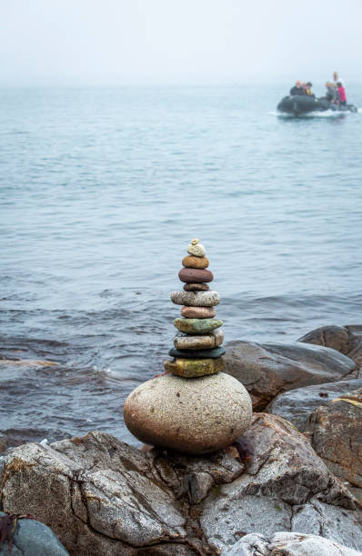 Stack of stones near the sea with water at background