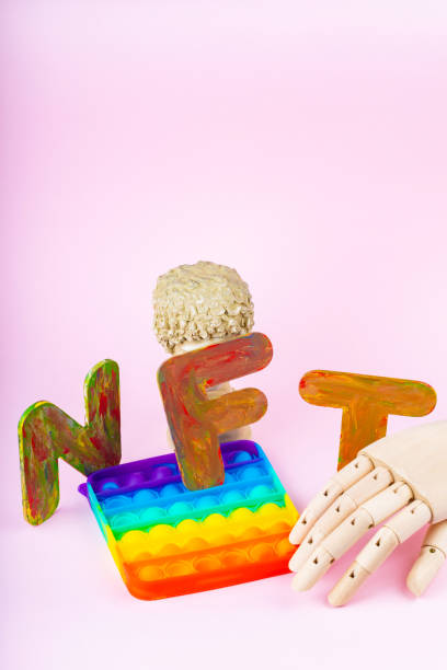 istock NFT Non-Fungible token. Concept for blockchain system. Classical statue and Pop it toy on a pink background. Crypto art concept with an artificial hand 1334331927