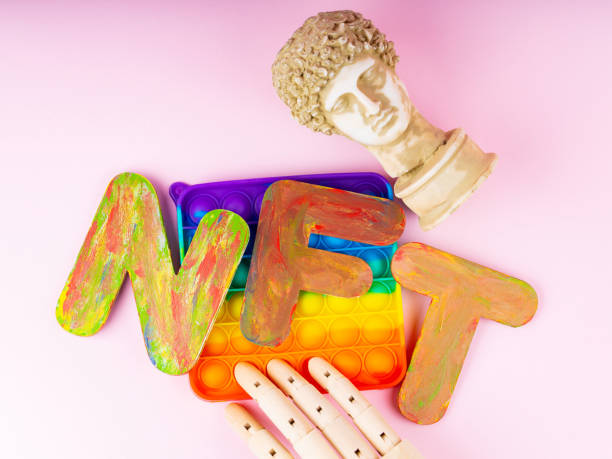 istock NFT Non-Fungible token. Concept for blockchain system. Classical statue and Pop it toy on a pink background. Crypto art concept with an artificial hand 1334331963