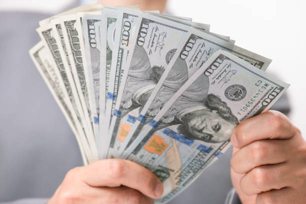 istock Women Giving Dollar 1334335352