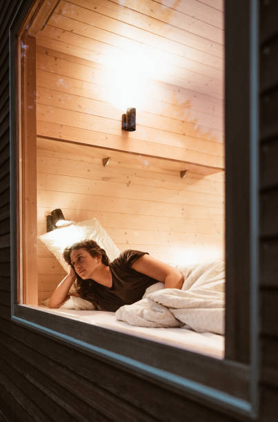 istock woman resting in a bed at home from a window 1334336724