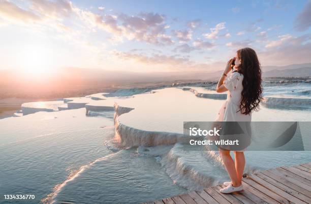 Beautiful Traveller Photographer Girl Is Taking Photos At Travertine Pools During Sunset In Pamukkale Stock Photo - Download Image Now