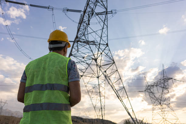 istock Engineers standing in front of power plant by sunset. 1334339009