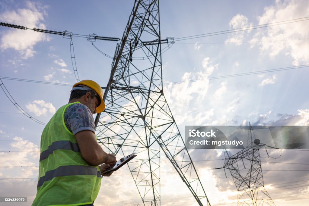 Engineers in front of power plant using digital tablet Fuel and Power Generation Stock Photo