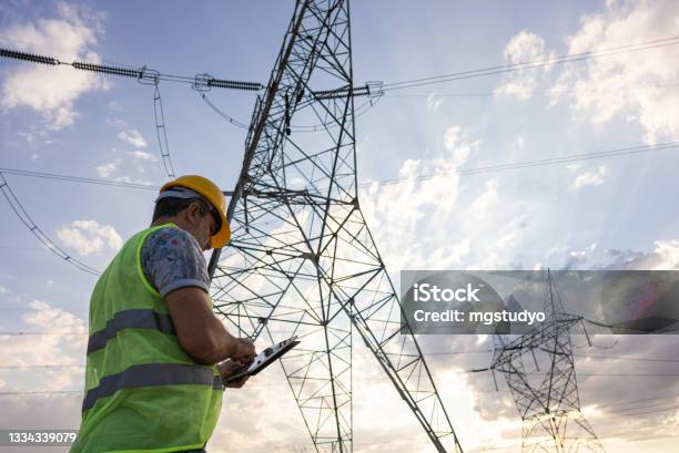 Engineers In Front Of Power Plant Using Digital Tablet Stock Photo - Download Image Now
