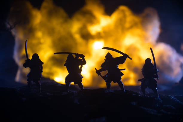 istock Samurai fighting concept. Silhouette of samurais in duel near tree and old temple. Table decoration with dark toned foggy background. Selective focus 1334340167