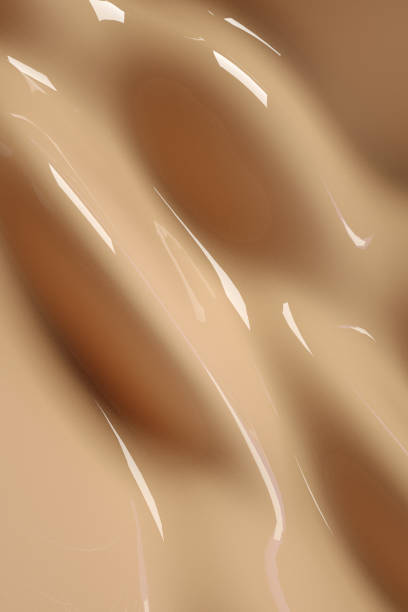 3D beige background with liquid foundation splash. Nude makeup cream fluid, beauty product, cosmetics promotion. Abstract vertical scene nude coloured stock pictures, royalty-free photos & images