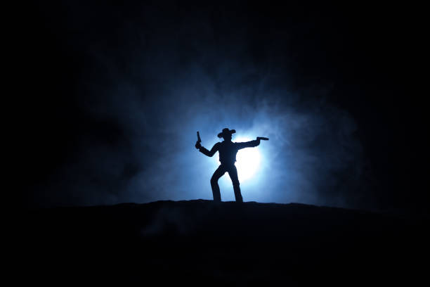 istock Western cowboy silhouette with texture at sunset and slivers of light 1334342023