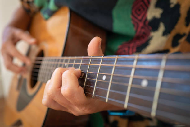 istock A person playing guitar with the front hand focused selectively 1334343200