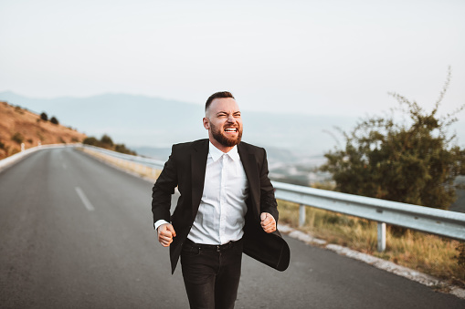 Angry Male Running From His Wedding Outside On Mountain