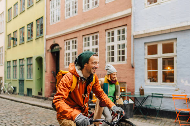 Couple enjoying the city ride Photo of tourists riding bicycles and enjoying the city ride copenhagen photos stock pictures, royalty-free photos & images
