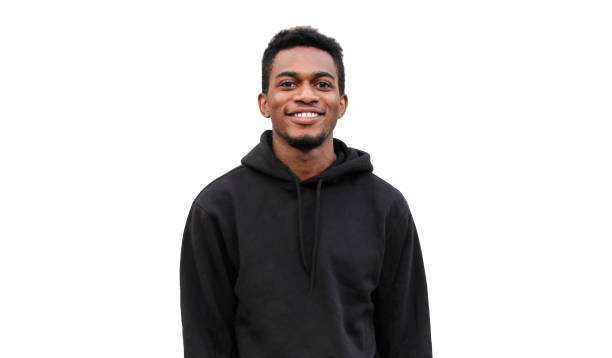 Portrait of modern smiling young african man looking at camera wearing a black hoodie isolated on white background stock photo