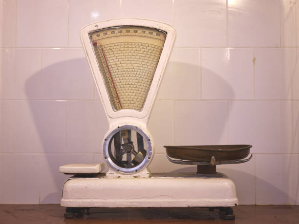 old grocer's scales on a white tiled wall
