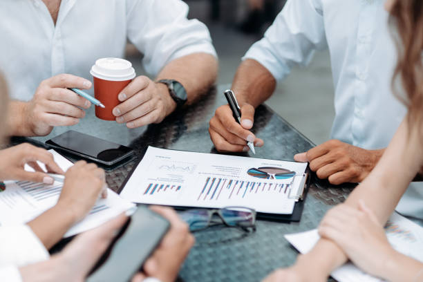 istock businessman using a smartphone during an office meeting 1334348604