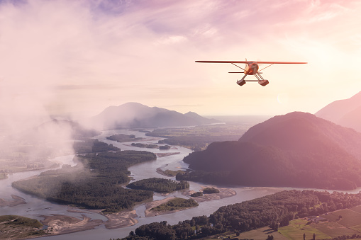 Composite Image of 3D CGI Seaplane flying over valley