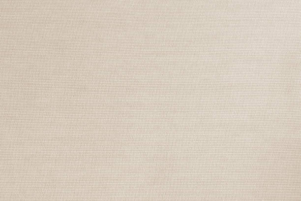 istock Cotton silk fabric wallpaper texture pattern background in light pastel sepia cream brown color tone 1334359263
