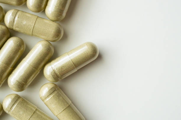 istock Herbal medicine capsules on white background 1334359674