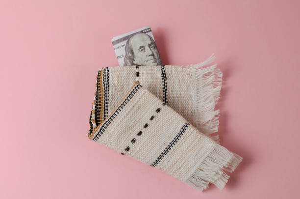 money and white fringed napkin on pink background. the one hundr - crumpled currency dollar folded imagens e fotografias de stock