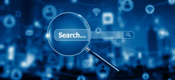 Photo of Search Engine Optimisation - SEO - with Magnifying glass on Network and Social Media.