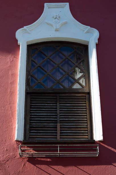 istock Antique window details in color with shadow, iron, cement, wood. 1334370209