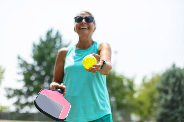 Mature Adult Female Playing Pickle Ball Photo Series In Western Colorado Mature Adult Female Playing Pickle Ball Photo Series Matching 4K Video Available (Shot with Canon 5DS 50.6mp photos professionally retouched - Lightroom / Photoshop - original size 5792 x 8688 downsampled as needed for clarity and select focus used for dramatic effect) pickleball stock pictures, royalty-free photos & images