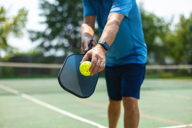 Mature Adult Male Playing Pickle Ball Photo Series In Western Colorado Mature Adult Male Playing Pickle Ball Photo Series Matching 4K Video Available (Shot with Canon 5DS 50.6mp photos professionally retouched - Lightroom / Photoshop - original size 5792 x 8688 downsampled as needed for clarity and select focus used for dramatic effect) pickleball equipment stock pictures, royalty-free photos & images