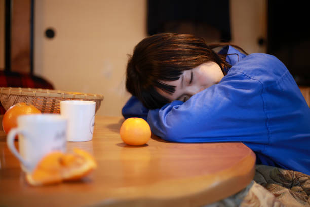 A woman sleeping on a kotatsu