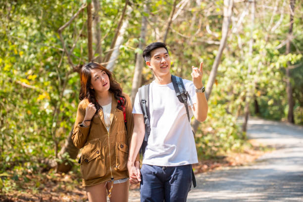 istock Asian couple hiking together in forest 1334377997