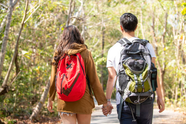 istock Asian couple hiking together in forest 1334378002