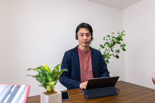 Portrait of Japanese businessman working from remote location