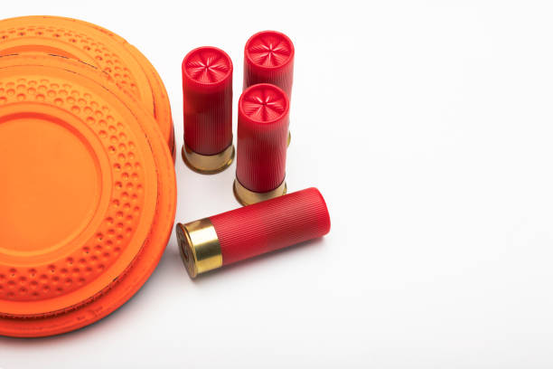 istock Clay shooting target and shotgun bullets on white background ,Clay Pigeon target game 1334383095