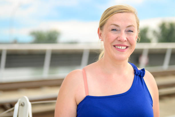 istock Happy friendly blond woman with a lovely beaming smile 1334387247
