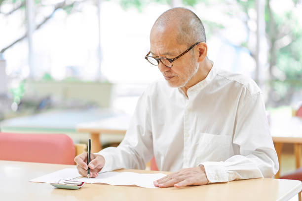 istock Elderly people thinking about what to write a suicide note / letter 1334390572