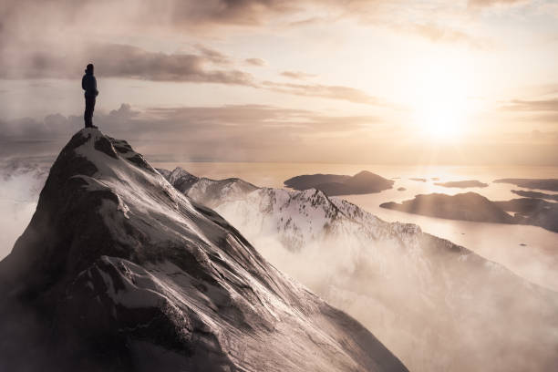 istock Man Standing on top of Rocky Mountain Cliff 1334390887