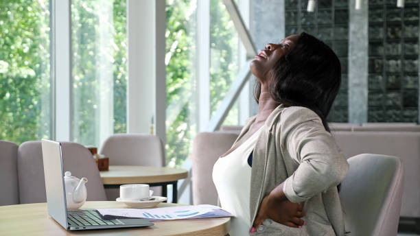 istock African-American lady types on laptop reading papers in cafe 1334395472