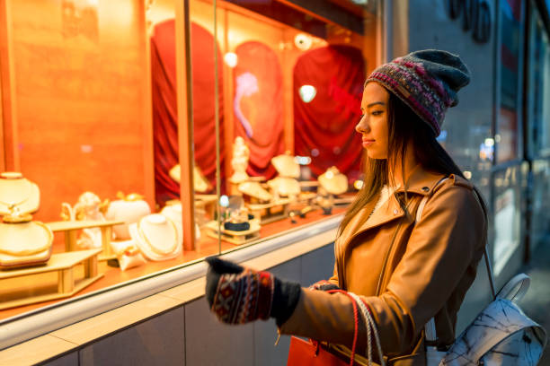 istock Women looking at jewelry store window 1334396592