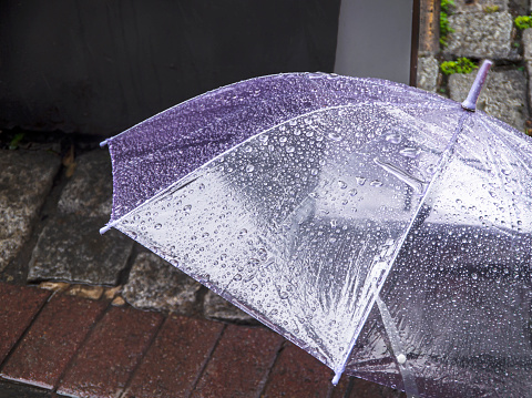 Transparent open umbrella with raindrops