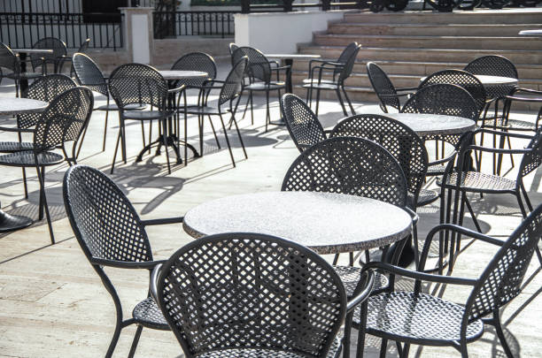 istock No guests. Tables  and chairs at a sidewalk restaurant 1334398143