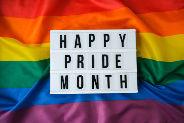 istock Rainbow flag with lightbox and text HAPPY PRIDE MONTH. Rainbow lgbtq flag made from silk material. Symbol of LGBTQ pride month. Equal rights. Peace and freedom 1334399920