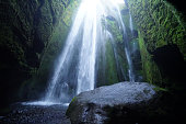 Waterfall Gljúfrabúi, like in cave hidden behind a big rocks, Iceland