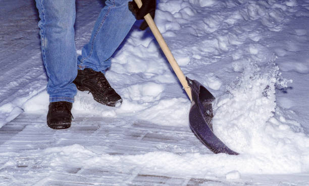 istock Man with snow shovel cleans sidewalks in winter. Winter time. 1334406935