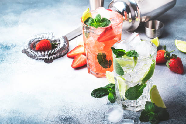 istock Mojito mocktail set with lime, mint, strawberry and ice in glass on gray background 1334408658