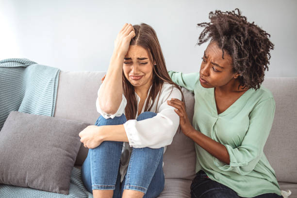 istock Two sad diverse women talking at home. 1334410420