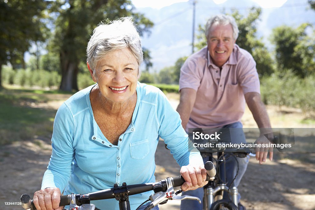 Senior couple on country bike ride Senior couple enjoying country bike ride together Senior Adult Stock Photo