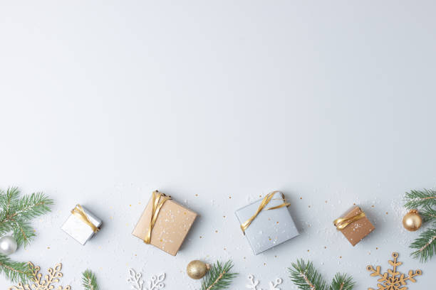 istock Christmas decorations with packaging gifts and Christmas tree on grey background. Flat lay, copy space 1334415699