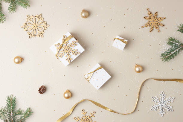 istock Christmas decorations with packaging gifts and Christmas tree on pastel beige background. Flat lay 1334415705