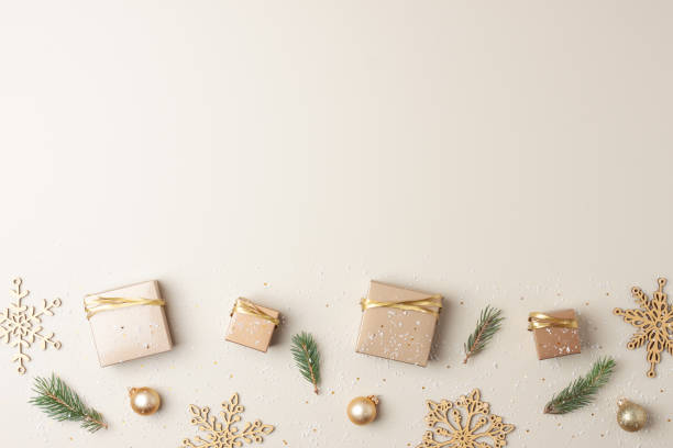 istock Christmas decorations with packaging gifts and Christmas tree on pastel beige background. Flat lay, copy space 1334415710