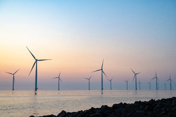 istock Wind turbines in an offshore wind park producing electricity during sunset. 1334416850