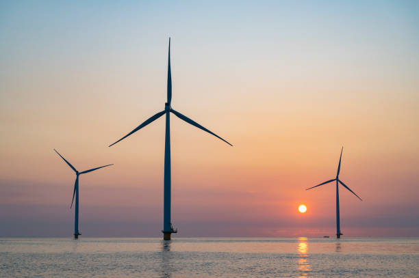 istock Wind turbines in an offshore wind park producing electricity during sunset. 1334416934